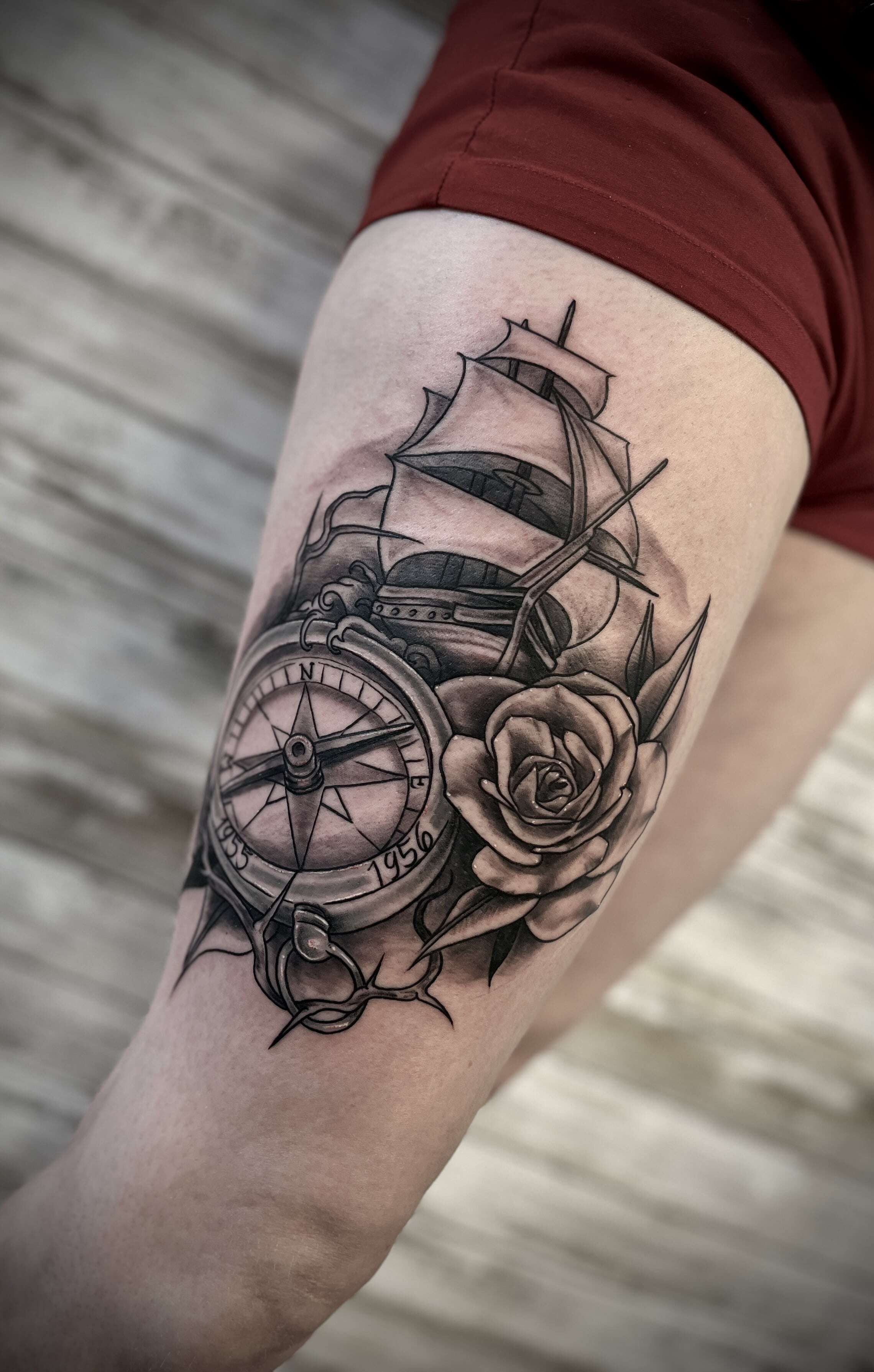 Ship with compass and flowers tattoo