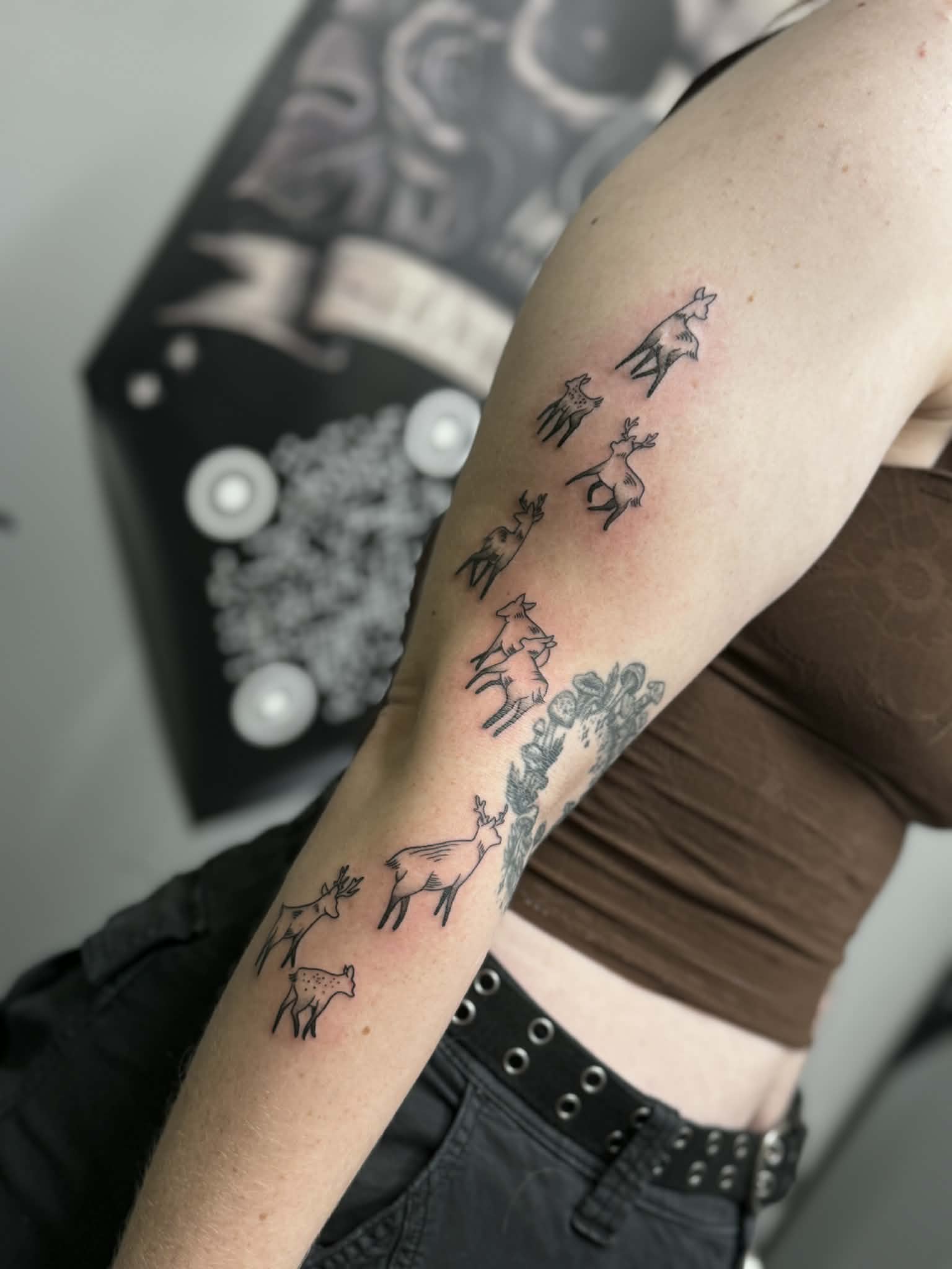 Small illustrative fine-line deer tattoos with delicate stippled shading, expertly tattooed by AJ at Poking Hazard’s private skin-informed studio in Edmonton, AB.
