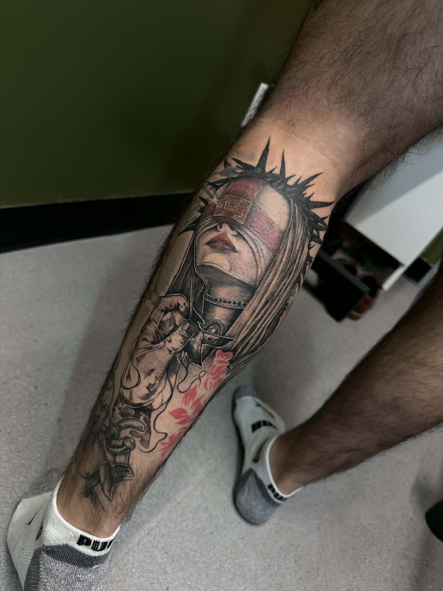 Detailed illustrative realism tattoo of a blindfolded woman with a crown of thorns and red accents, expertly executed by AJ at Poking Hazard’s private skin-informed studio in Edmonton, AB.